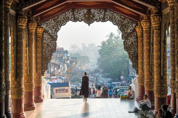 Buddhism: Buddhist Monk Passing The Entrance Of The Shwedagon Pagoda In Yangon, Myanmar by Jan Becke