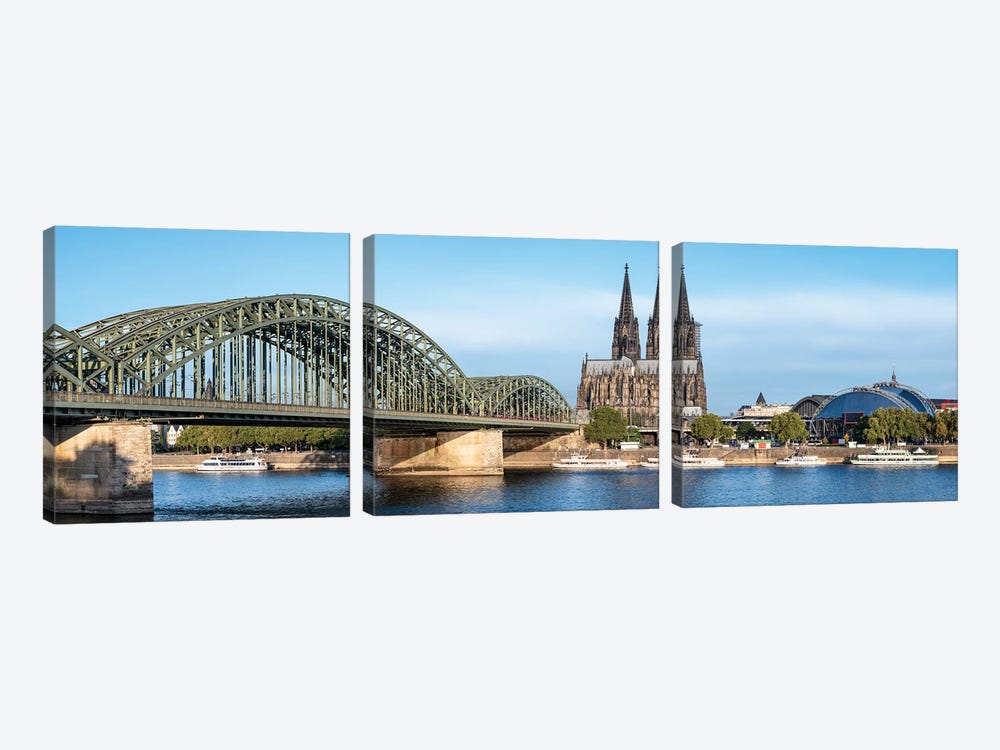 Panoramic View Of The Cologne Cathedral And Hohenzollern Bridge Along The Rhine River by Jan Becke 3-piece Art Print