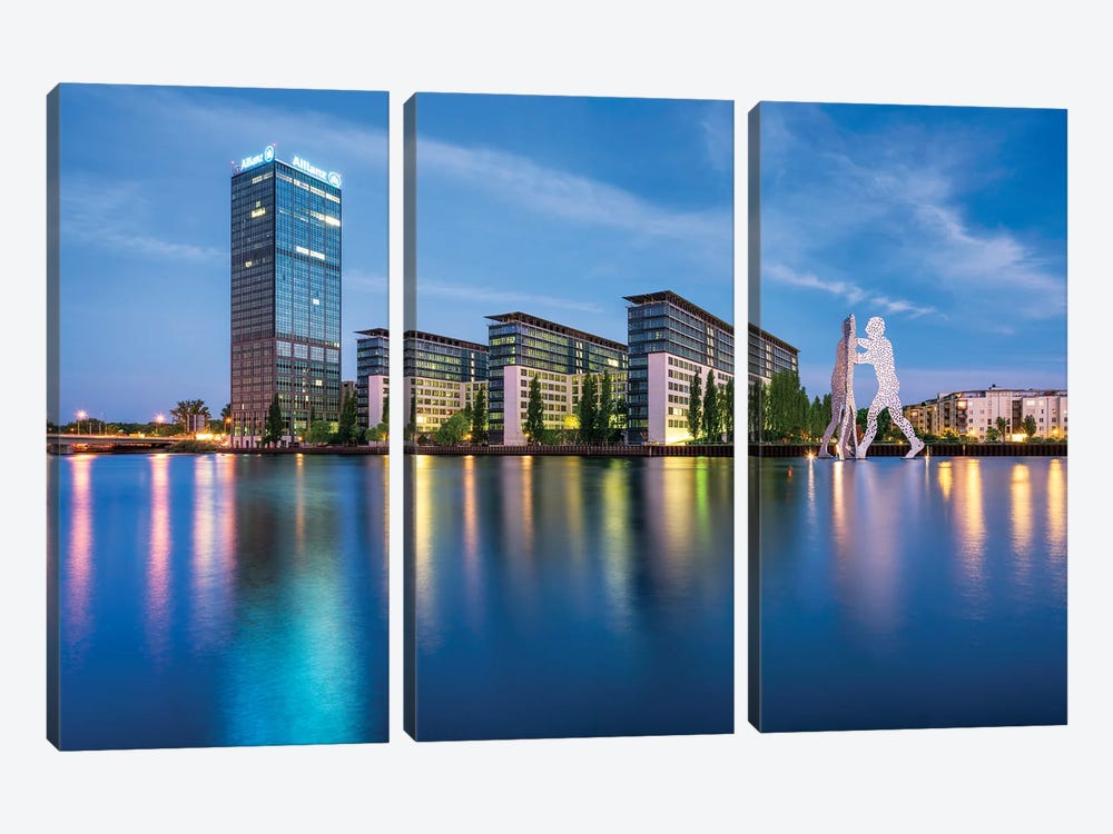 Treptowers And Molecule Man Sculpture Along The Spree River, Berlin, Germany by Jan Becke 3-piece Canvas Print