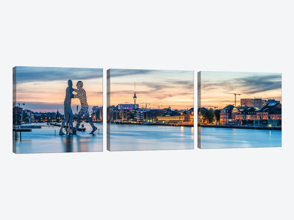 Berlin Skyline With Molecule Man Sculpture Along The Spree River At Sunset by Jan Becke 3-piece Canvas Print