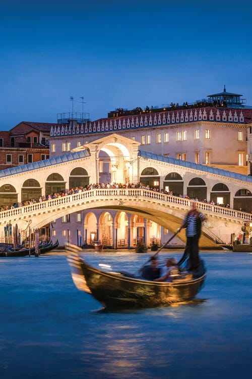 Gondola With Tourists In Front Of Rialto Bridge