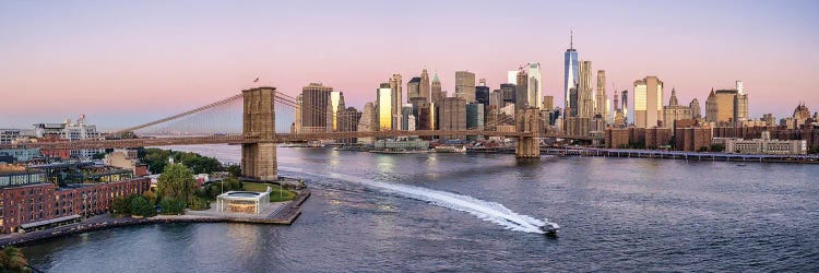 Manhattan skyline panorama with Brooklyn Bridge and East River at sunrise