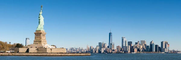 New York City Skylines: Statue Of Liberty In Front Of The Manhattan Skyline by Jan Becke