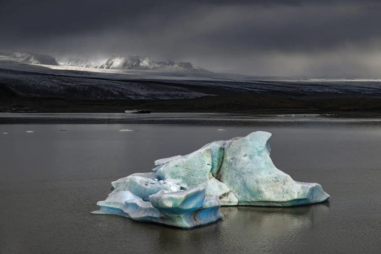 Iceberg Against Stormy Skies And Sunlight