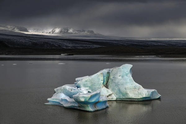 Glaciers & Icebergs: Iceberg Against Stormy Skies And Sunlight by Jane Rix
