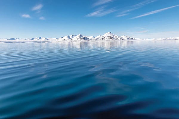Blue Arctic Ocean And Svalbard Mountains