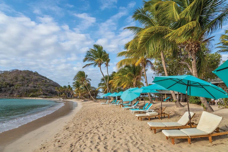 Caribbean, Grenada, Mayreau Island. Beach umbrellas and lounge chairs.