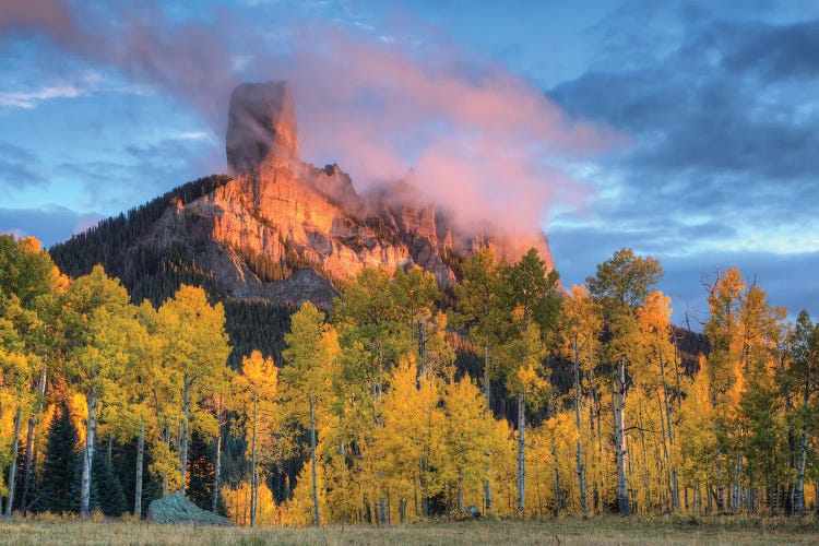 USA, Colorado, San Juan Mountains. Chimney Rock formation and aspens at sunset.