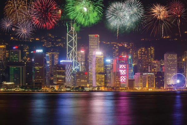 Fireworks: China, Hong Kong. Fireworks over city at night. by Jaynes Gallery