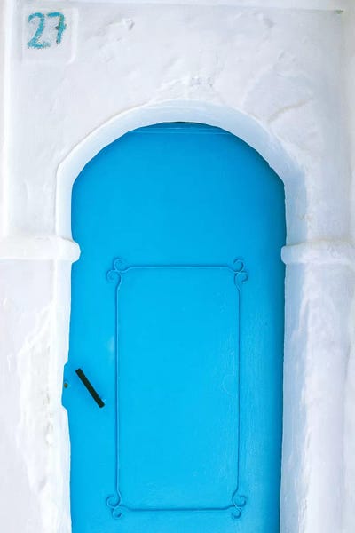 Africa, Morocco, Chefchaouen. Blue door in white building.