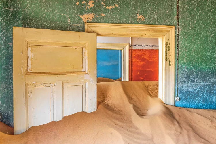 Africa, Namibia, Kolmanskop. Doorways and drifting sand in an abandoned diamond mining town.