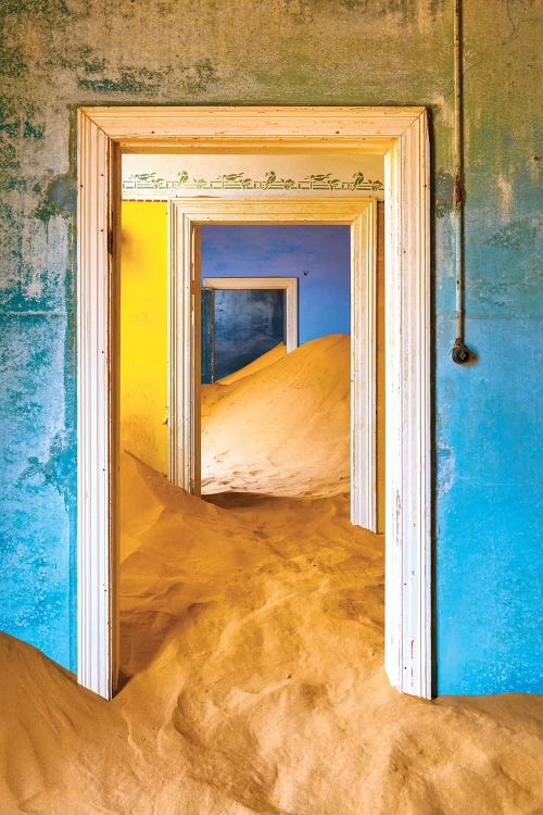 Africa, Namibia, Kolmanskop. Doorways and drifting sand in an abandoned diamond mining town.