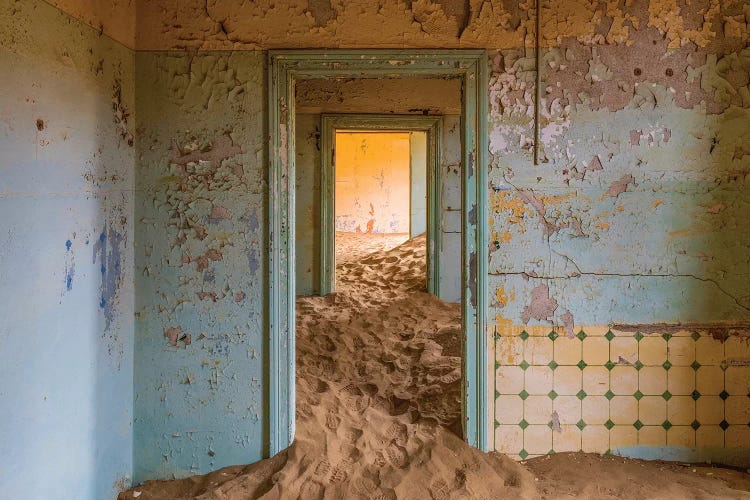 Africa, Namibia, Kolmanskop. Doorways and drifting sand in an abandoned diamond mining town.