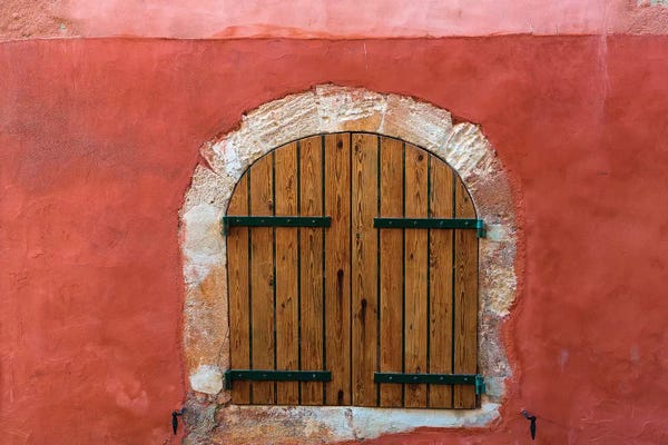 France, Provence, Roussillon. Wooden shutters in red wall.