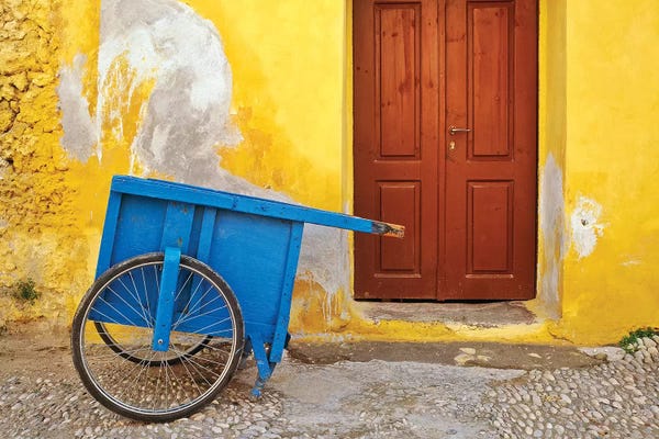 Greece, Rhodes. House with blue cart in front.