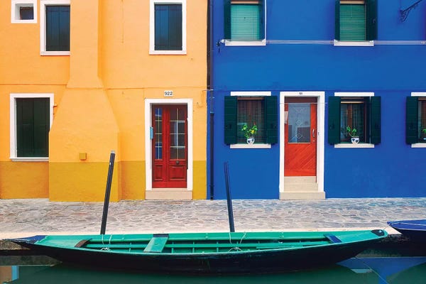 Italy, Burano. Colorful house exteriors and boat in canal.