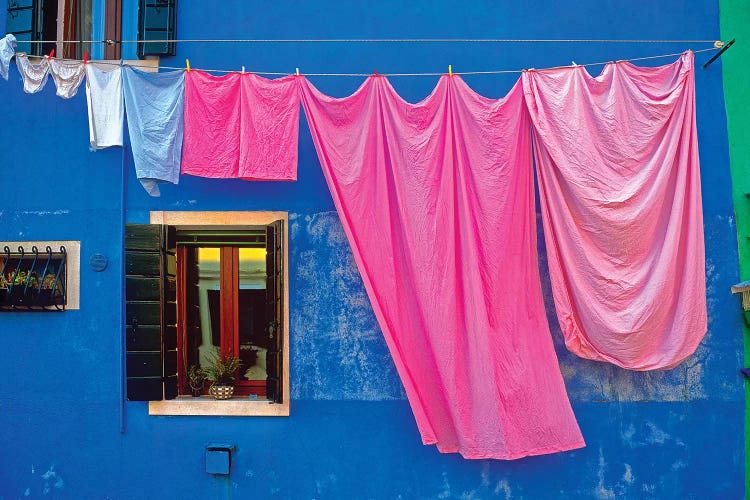 Italy, Burano. Drying laundry and colorful window and wall. 