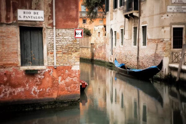 Italy, Venice. Gondola moored in canal.