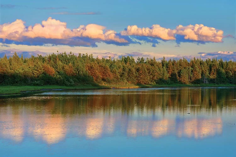 Canada, New Brunswick, Richibucto. Clouds reflected in an inlet at sunset.