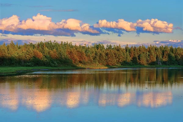 Canada, New Brunswick, Richibucto. Clouds reflected in an inlet at sunset.