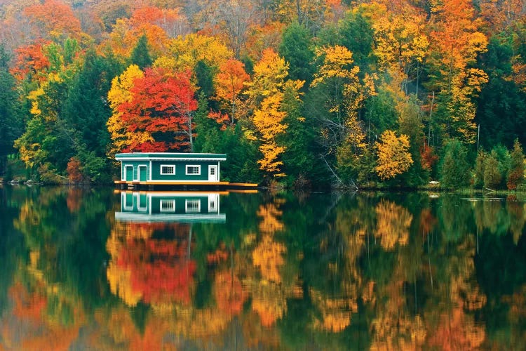 Canada, Ontario, Rosseau. Boathouse and reflection in autumn.