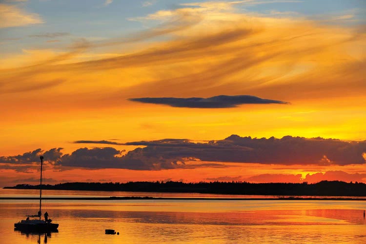 Canada, Prince Edward Island, Wood Islands. Sailboat at sunset.