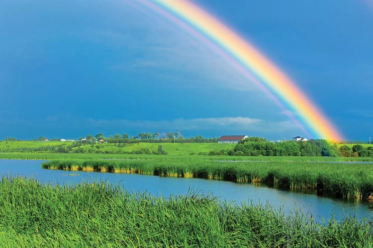 Canada, Quebec, St. Gedeon. Rainbow and barn after storm.