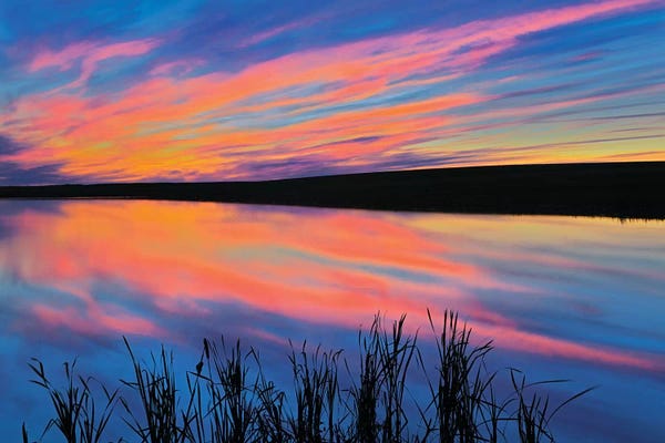 Canada, Saskatchewan, Viscount. Sunset reflected in pond.