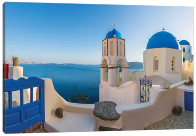 Greece, Oia. Sunrise on Greek Orthodox church and village.  Canvas Art Print - Blue Domed Church Santorini