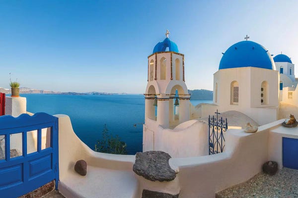 Greece, Oia. Sunrise on Greek Orthodox church and village.