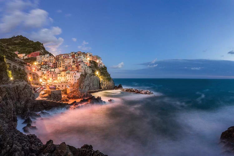 Italy, Cinque Terre, Manarola. Hilltop town and stormy ocean at sunset. 