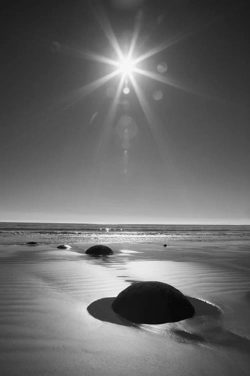 New Zealand, South Island. BW starburst over Moeraki Boulders Scenic Reserve.