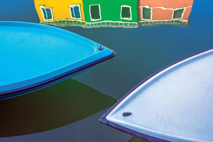 Italy, Burano. Boat Bows And House Reflection In Canal.