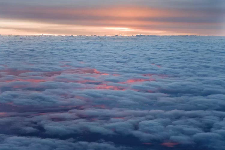 Sunrise From An Airliner Looking Down At Clouds.