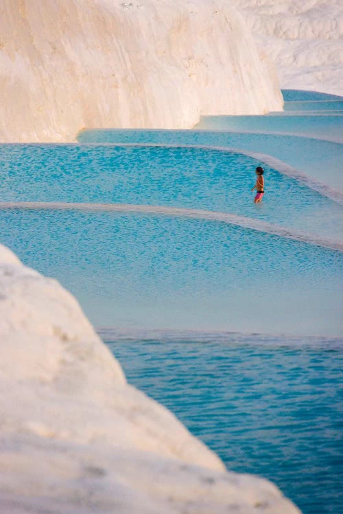 Young girl on travertine terraces of Pamukkale, Turkey