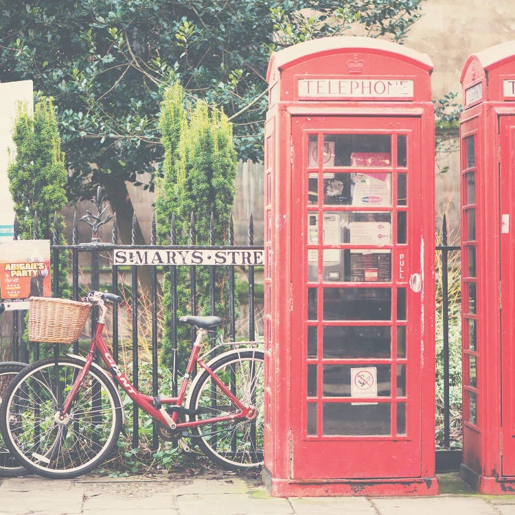 A Red Bicycle And Telephone Boxes