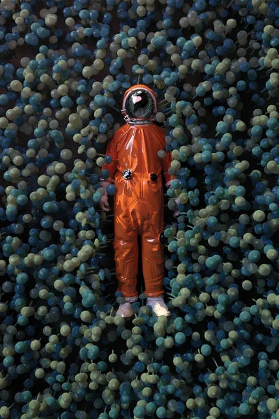 Mike Kiev: Astronaut Lying In Mushrooms by Mike Kiev