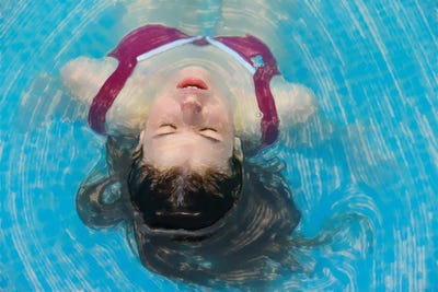 Young Woman Relaxing In The Pool by Mike Kiev art print