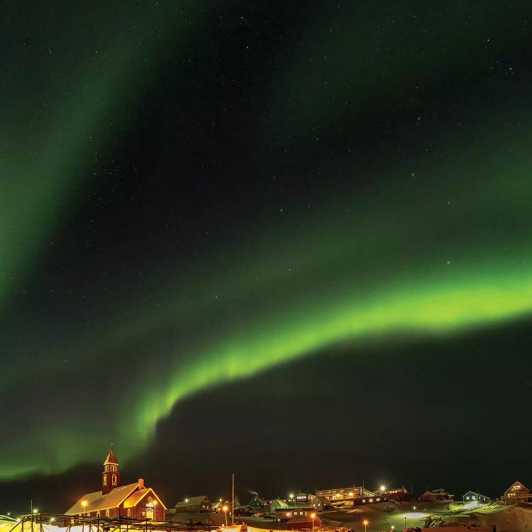 Northern Lights over town and frozen Disko Bay. Greenland.
