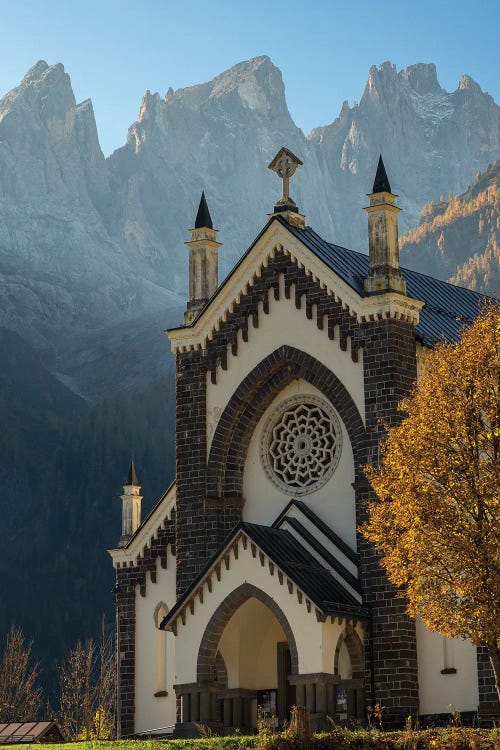 Chiesa di San Sebastiano in Falcade in Val Biois, in the background the Focobon mountain range, Pale di San Martino. Italy.