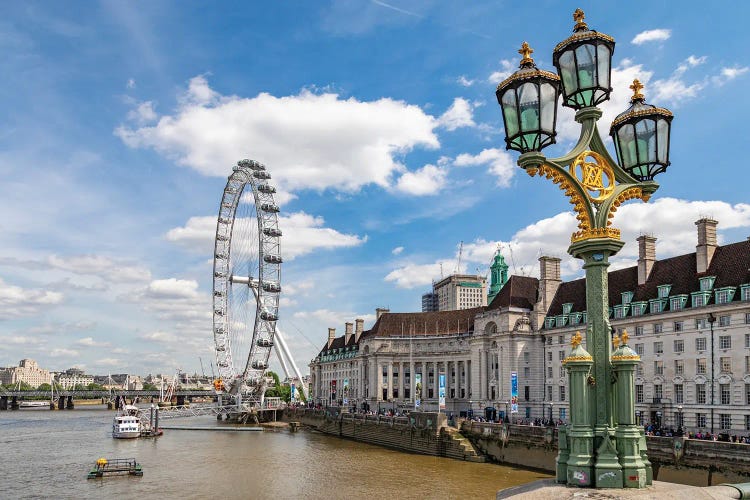 The London Eye and iconic British lamppost in London, England.