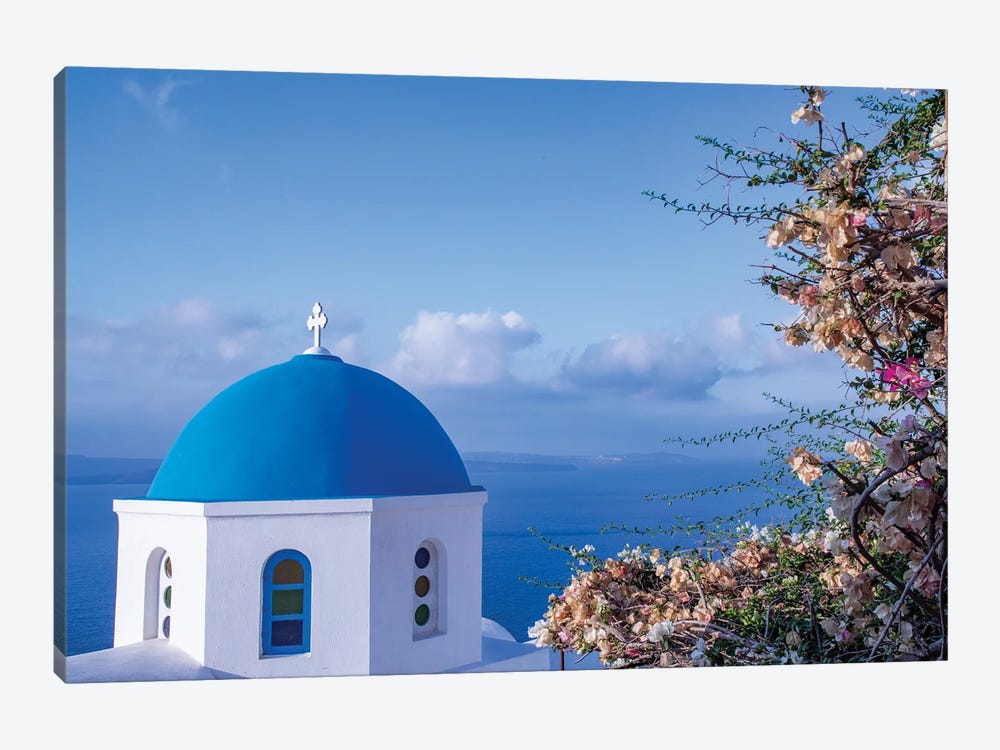 Blue domed Greek Orthodox church with bougainvillea flowers in Oia, Santorini, Greece. by Michele Niles 1-piece Canvas Art Print