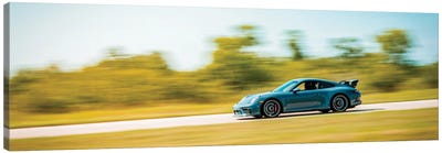 Blue Porsche On The Track In Motion Canvas Art Print