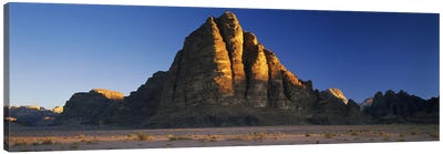 Rock formations on a landscapeSeven Pillars of Wisdom, Wadi Rum, Jordan Canvas Art Print - Jordan