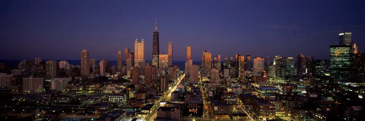 Skyscrapers in a city lit up at dusk, Chicago, Illinois, USA