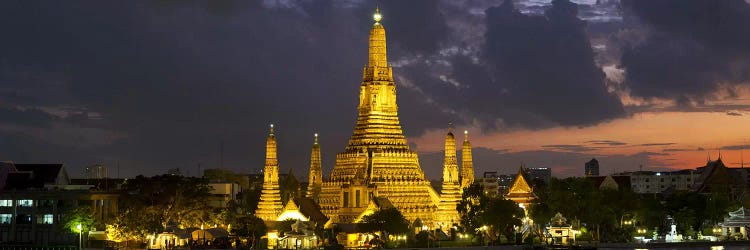 Buddhist temple lit up at dawn, Wat Arun, Chao Phraya River, Bangkok, Thailand