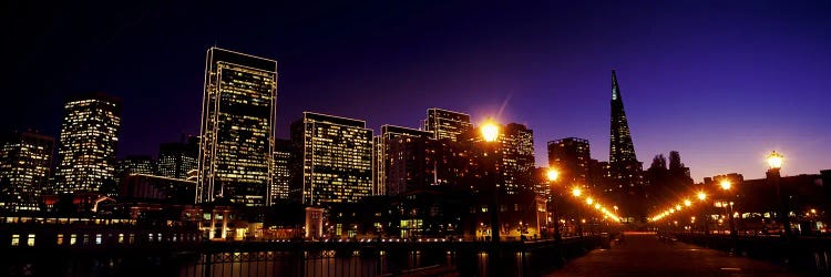 Buildings at the waterfront lit up at dusk, San Francisco, California, USA