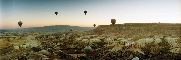 Hot air balloons over landscape at sunrise, Cappadocia, Central Anatolia Region, Turkey