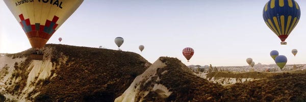 Extreme Sports: Hot air balloons over landscape at sunrise, Cappadocia, Central Anatolia Region, Turkey #2 by Panoramic Images