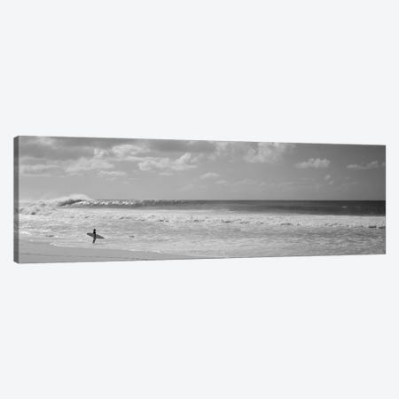 Surfer standing on the beach, North Shore, Oahu, Hawaii, USA Canvas Print #PIM11701} by Panoramic Images Canvas Wall Art
